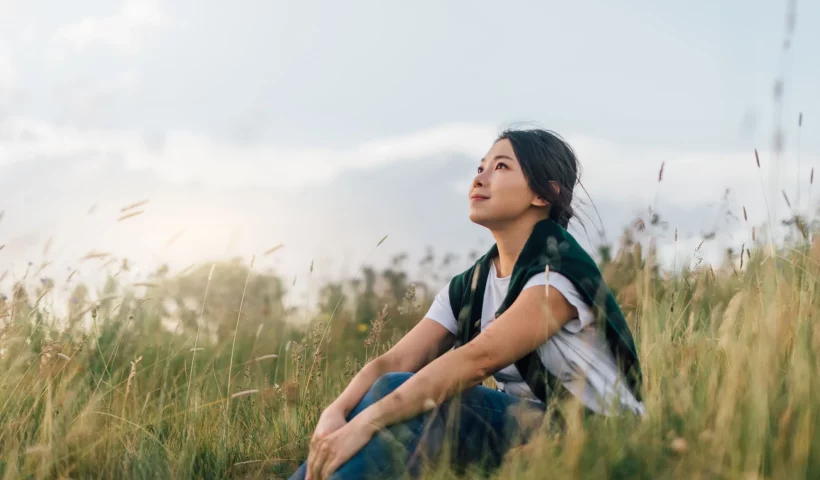 Mindful-mindfulness-enjoying-nature-woman-sitting enjoying nature-savouring-savoring